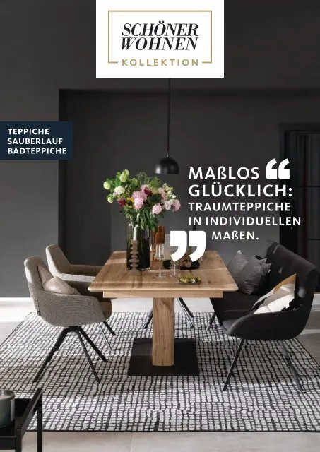 Teppiche SCHÖNER WOHNEN 2023 Holztisch mit schwarzen Stühlen und Blumenarrangement, umgeben von einem gemusterten Teppich.