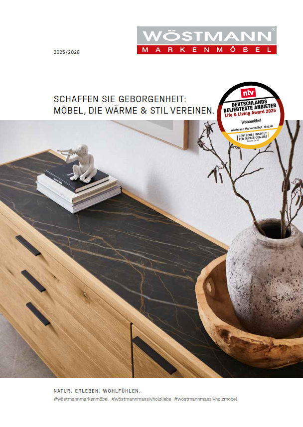 Wöstmann Wohnraum Katalog 2025/2026 Katalogcover für Wöstmann Markenmöbel 2025/2026 mit Holzkommode und dekorativen Objekten.